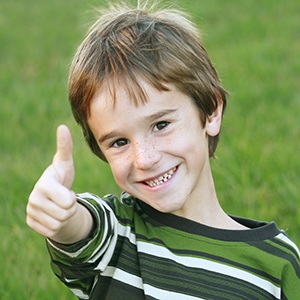 Young boy giving excited thumbs up