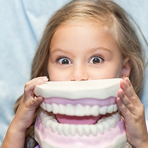 girl with model of teeth