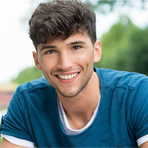 A teenaged boy smiling.