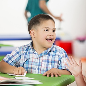 Young boy grabbing paper smiling