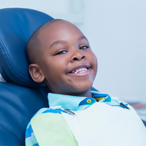 Young boy smiling in dental chair