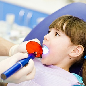 A little girl getting a filling from a dentist
