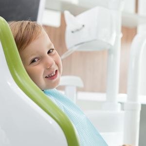 Young boy smiling in dental chair