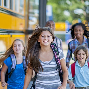 Naperville Restorative Dentistry Kids walking by school bus