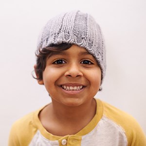 Young boy with beanie smiling