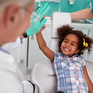little girl giving her dentist a high-five