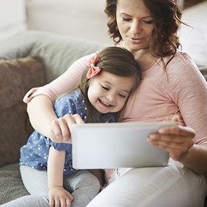 Mother and Daughter enjoying playing on tablet