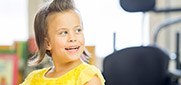 Young child sitting on dental chair looking back