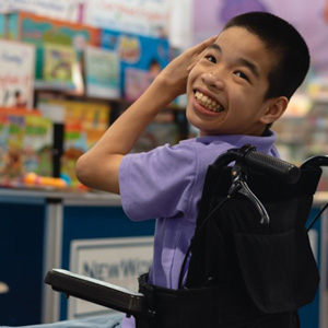 Child in a wheelchair smiling brightly
