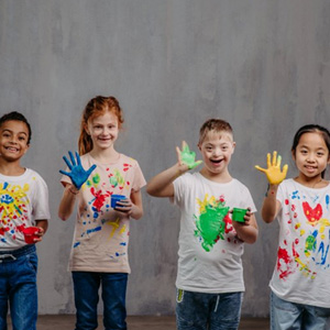 Kids with hand paint wearing colorful shirts
