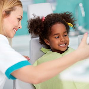 Young girl smiling on dental chair