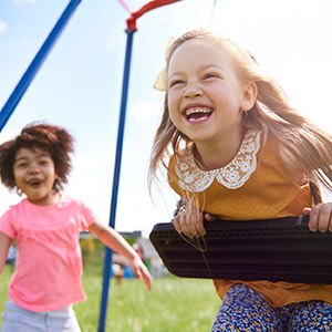 Girls playig on swings