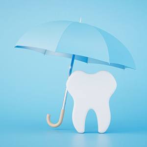 Tooth model under blue umbrella