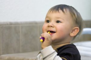 A toddler brushing his teeth.