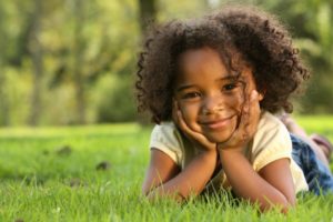 little girl curly hair smiling