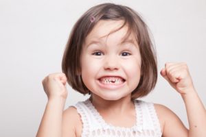 a little girl with missing teeth