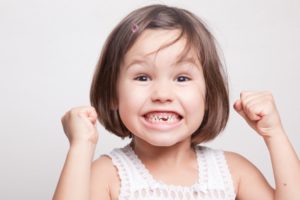 a little girl with missing teeth