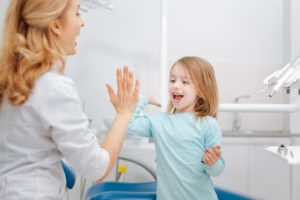 child giving dentist a high-five