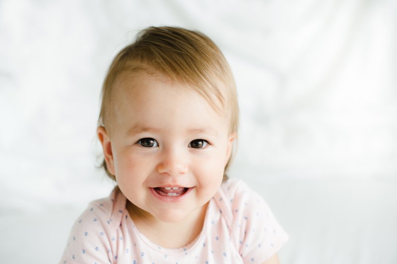 Closeup of toddler smiling with baby teeth