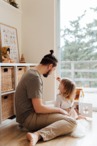 Young girl playing with her father