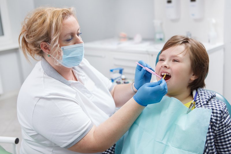 child receiving fluoride at the dentist’s office