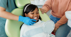a child and parent smiling during a dental visit